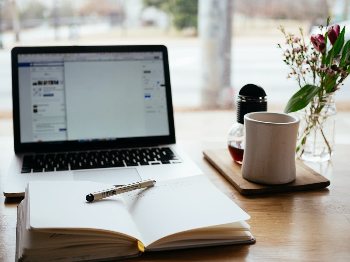 Laptop book pen and cup