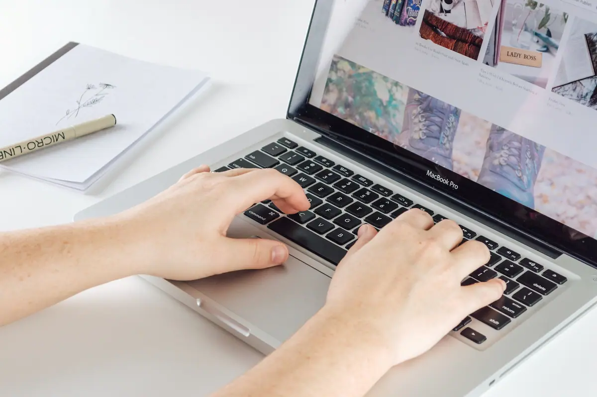 Blogger typing on macbook pro